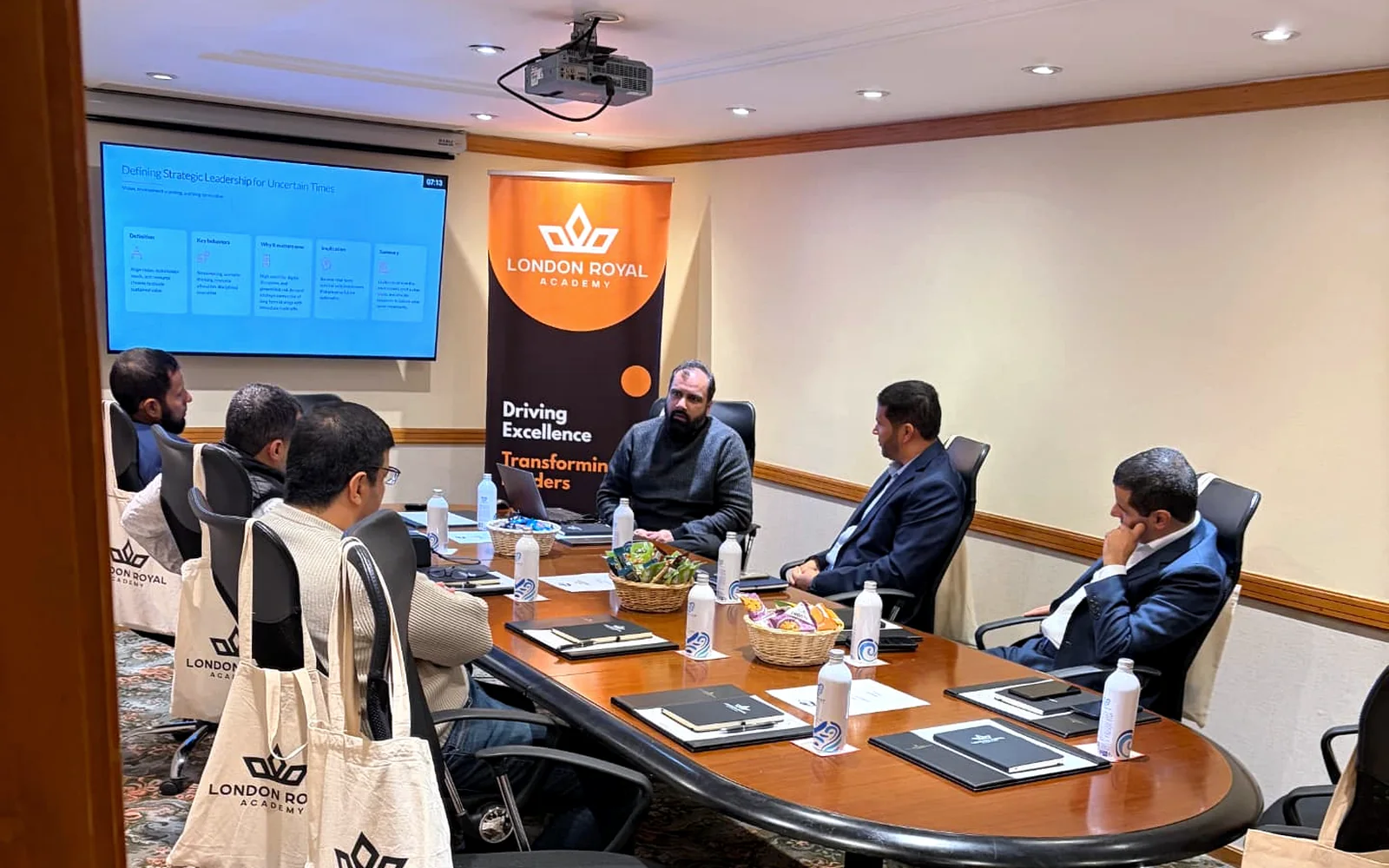 Professionals taking part in a London Royal Academy workshop around a boardroom table